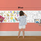 The image depicts a father and his two daughters enjoying a bonding moment while colouring alphabets sheet attached to the wall.