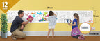 The image depicts a father and his two daughters enjoying a bonding moment while colouring aquarium sheet attached to the wall.