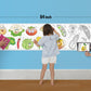 The image depicts a father and his two daughters enjoying a bonding moment while coloring vegetables sheet attached to the wall.