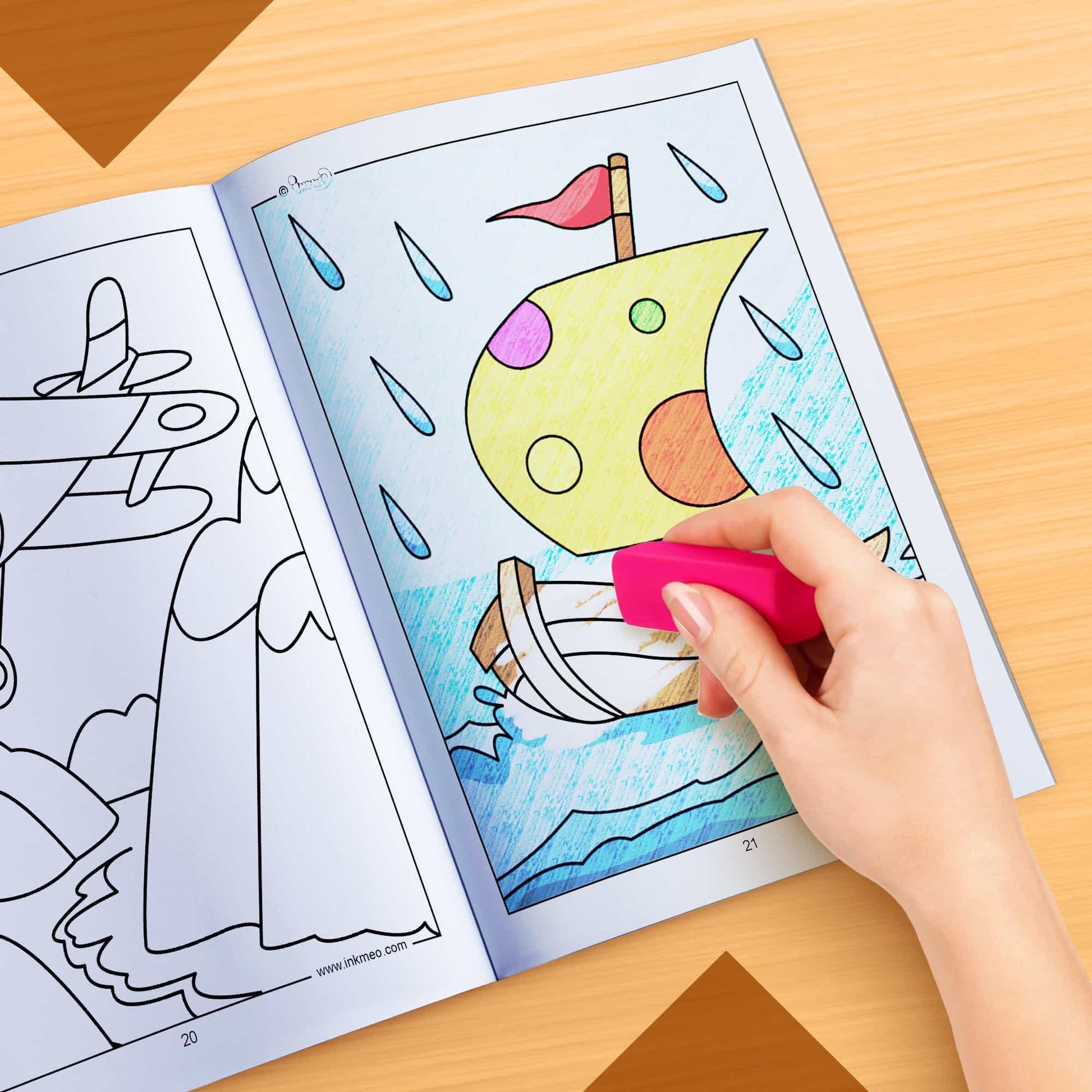 The image depicts a hand using an eraser to erase crayon marks in a colouring book.