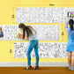 The image depicts a yellow wall with three rolls attached to it, being colored by children. The size of the rolls is specified as 18 inches in the top left corner.
