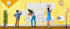 The image depicts a yellow wall with three rolls attached to it, being colored by children. The size of the rolls is specified as 18 inches in the top left corner.